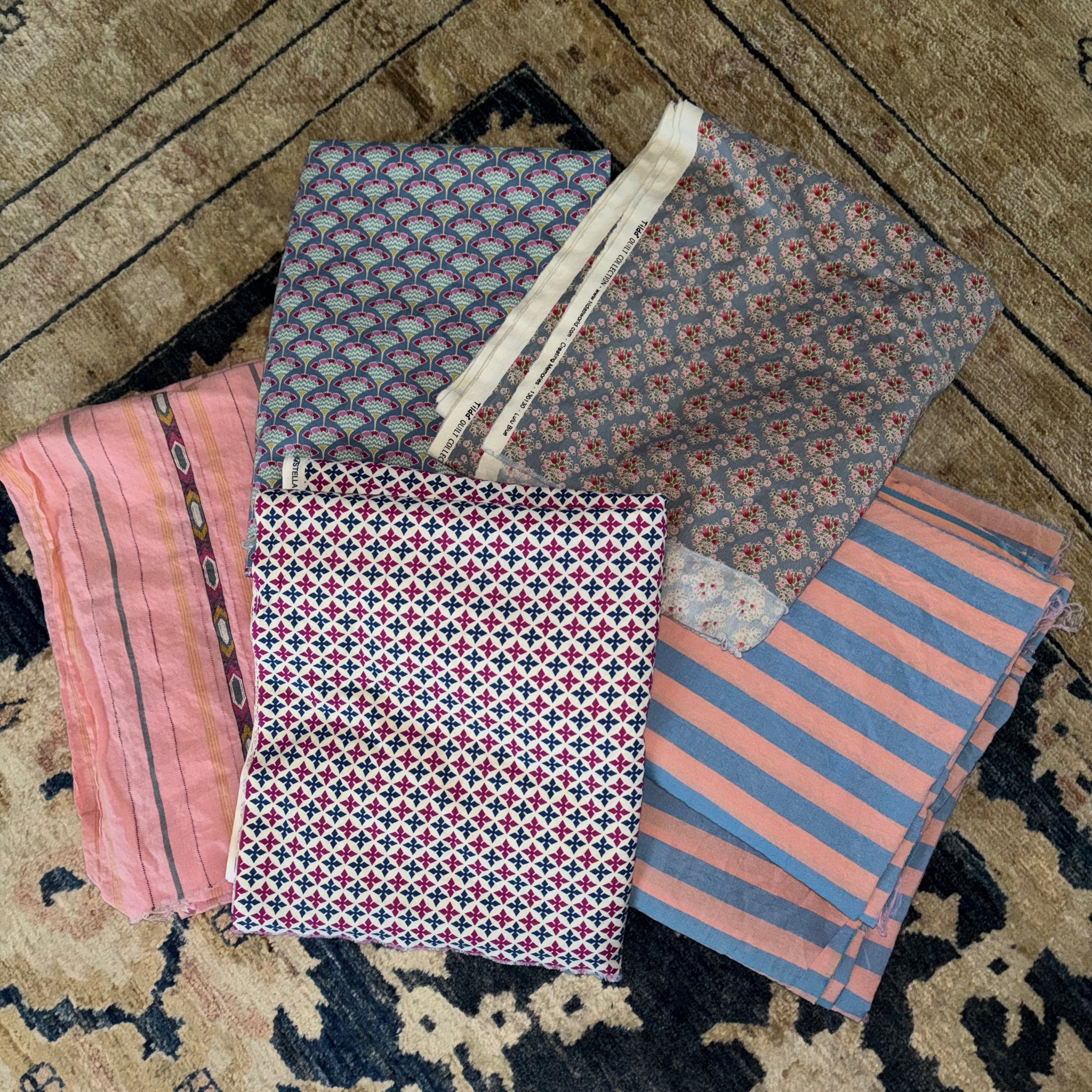 Picture of a pile of pastel colored fabrics