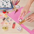 A woman using 45mm Rotary Cutter on fabric