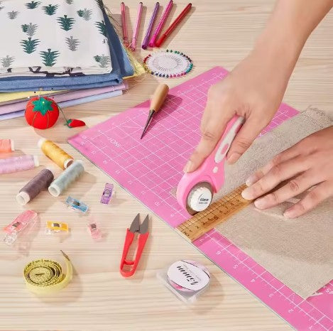 A woman using 45mm Rotary Cutter on fabric
